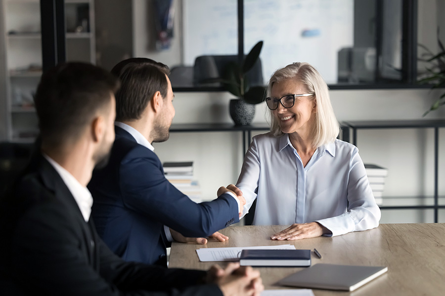 two men and a woman in a buiness meeting