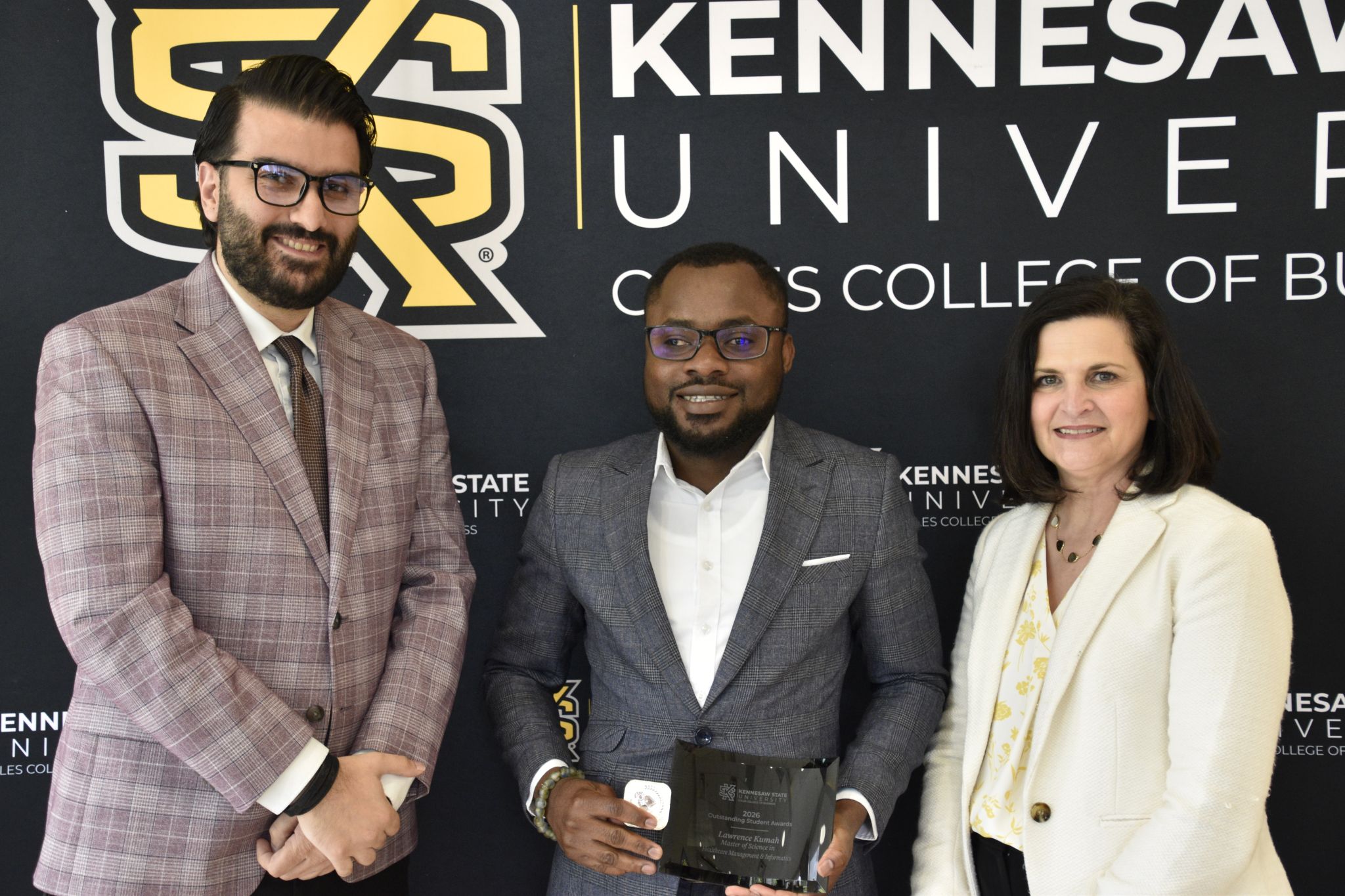 Outstanding Student, Lawrence Kumah, stands with Hossein Mohit and Robin Cheramie