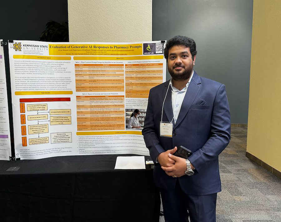 Dr. Abrar Hussain Syed standing with his research