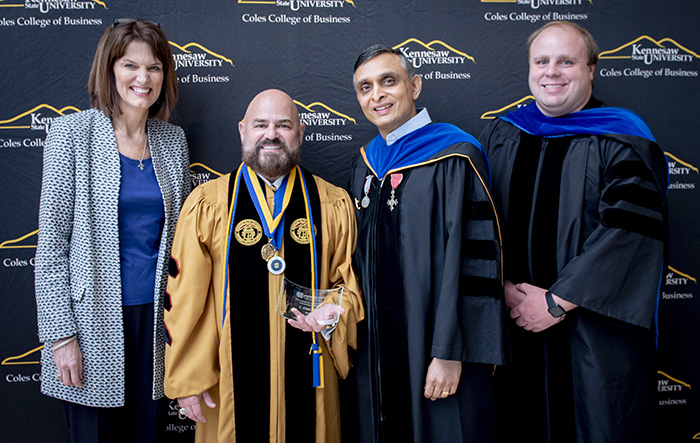 Coles Business Administration faculty posing together at commencement ceremony