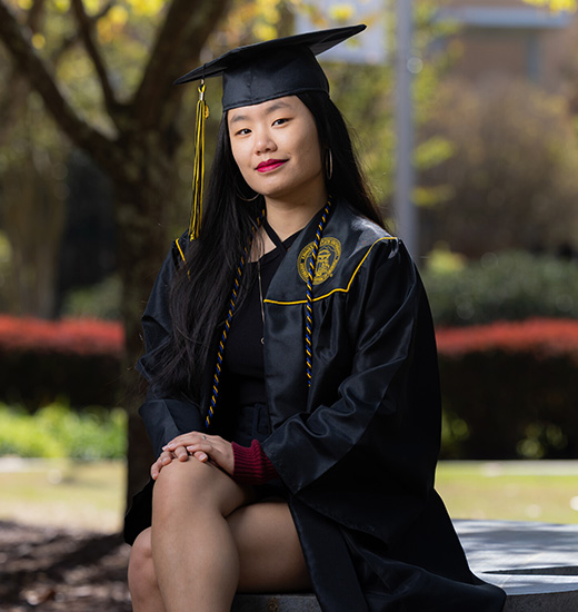 a student dressing in a cap and gown