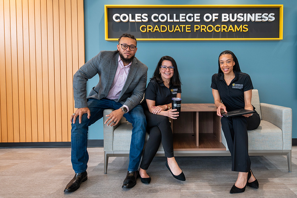 Three EMBA students sitting together in the Coles graduate building