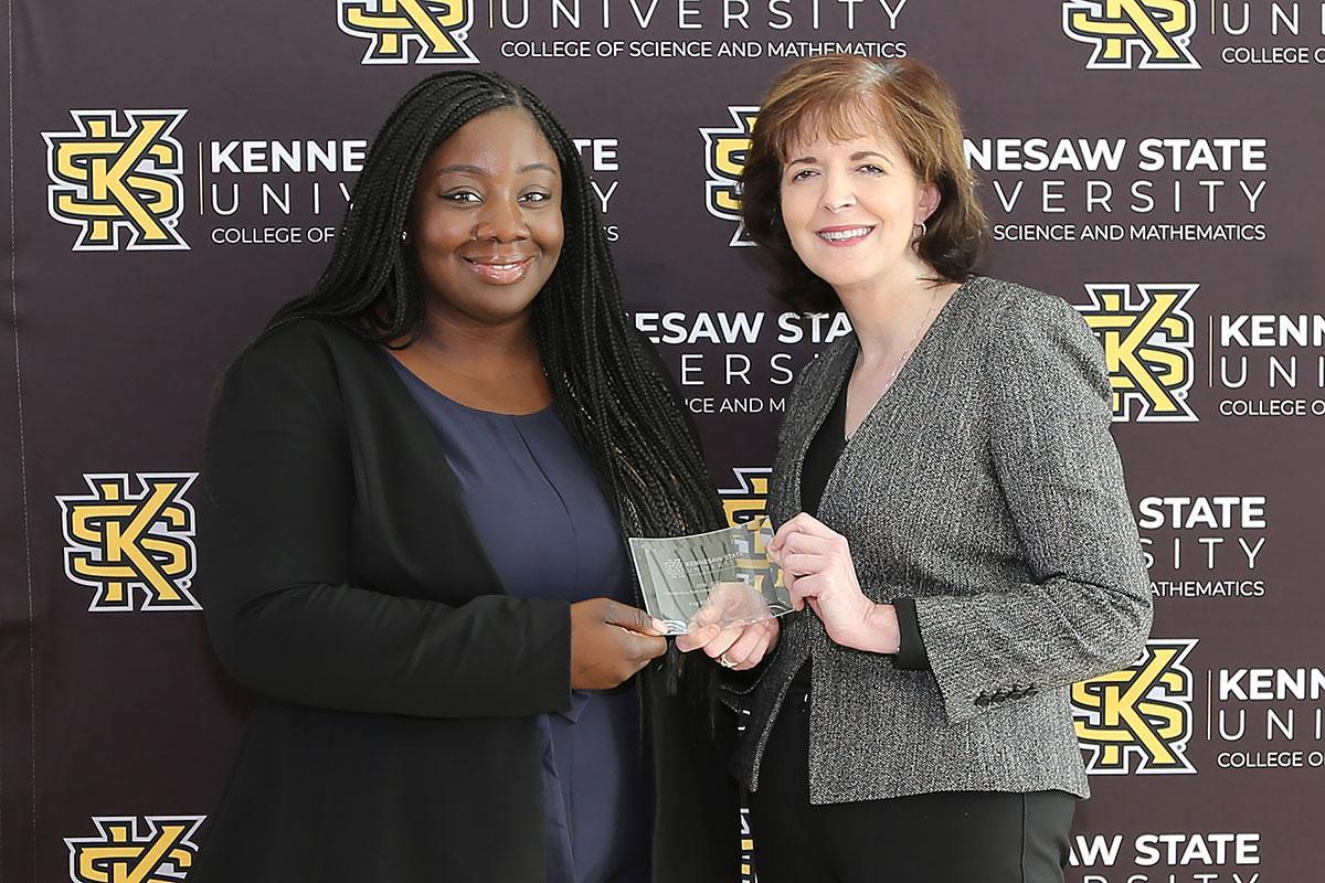  / Photo of the Outstanding Part-time Teaching Award winner, Kay Abikoye, Part-Time Instructor of Environmental Science (EEOB), (left) and Dr. Marla Bell, Interim Dean (right) 