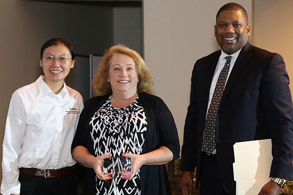  / (Left to right) Photo of Sherry Ni, Ph.D., Chair of the Department of Statistics and Analytical Sciences (left), Distinguished Part-time Award recipient, Melony Parkhurst (middle), and Adrian Epps, Ph.D., Associate Dean for External Affairs (right). 