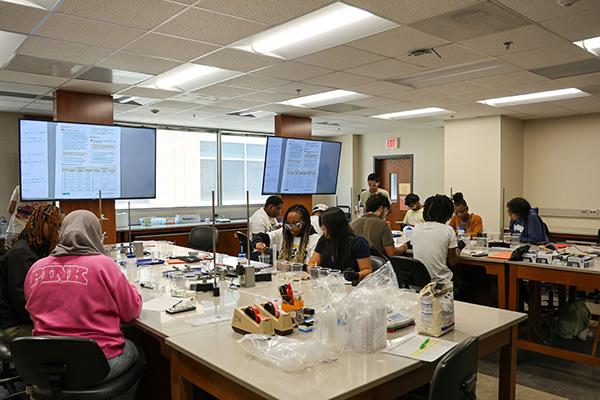 CSM PRESS program students collaborating in a science lab, engaged in a chemistry / CSM PRESS program students collaborating in a science lab, engaged in a chemistry