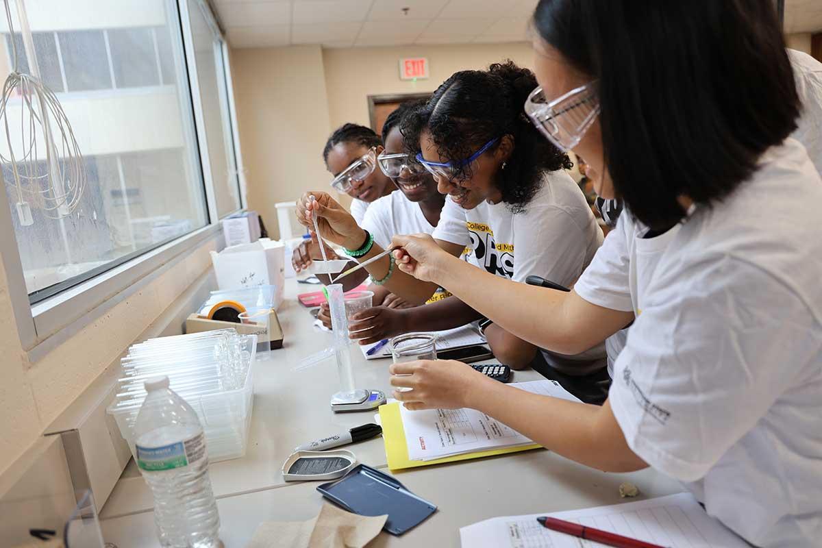 CSM PRESS program students collaborating in a science lab, engaged in a chemistry experiment.  / CSM PRESS program students collaborating in a science lab, engaged in a chemistry experiment. 