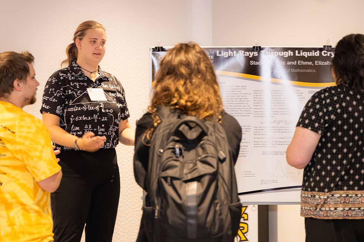 Math student presenting a research poster presentation at the Birla Carbon Symposium.  / Math student presenting a research poster presentation at the Birla Carbon Symposium. 