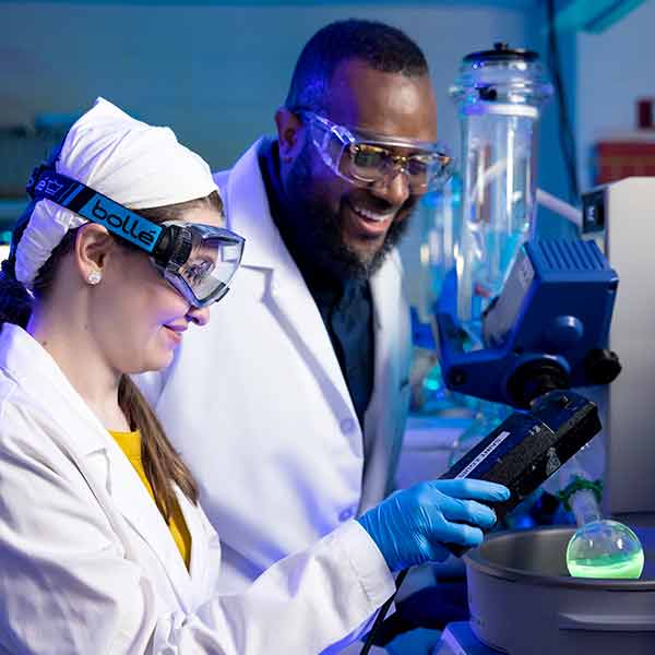 Faculty and student working on chemistry research in a laboratory