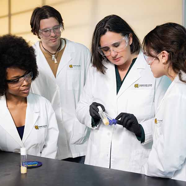 Molecular and Cellular Biology faculty and students working on research in a laboratory