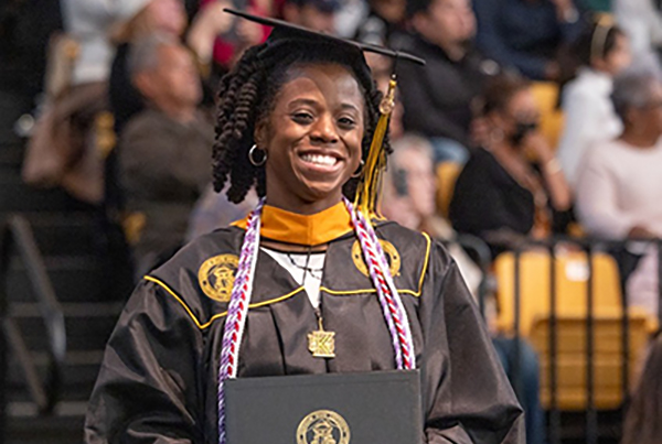 graduate in cap and gound after receiving her diploma