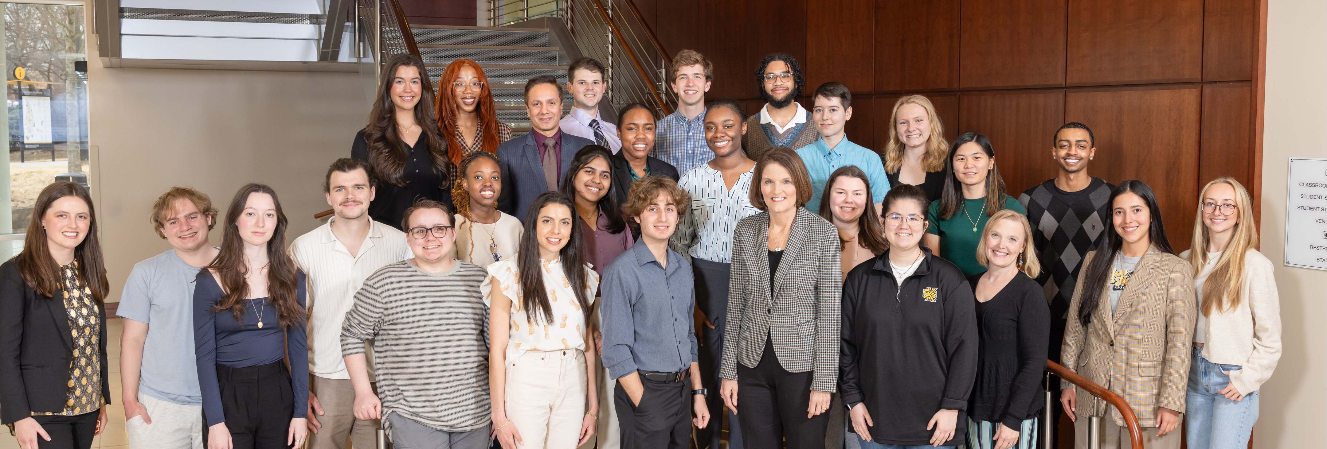 A group of Kennesaw State University Honors students take a group photo with President Schwaig and Provost Pulinkala