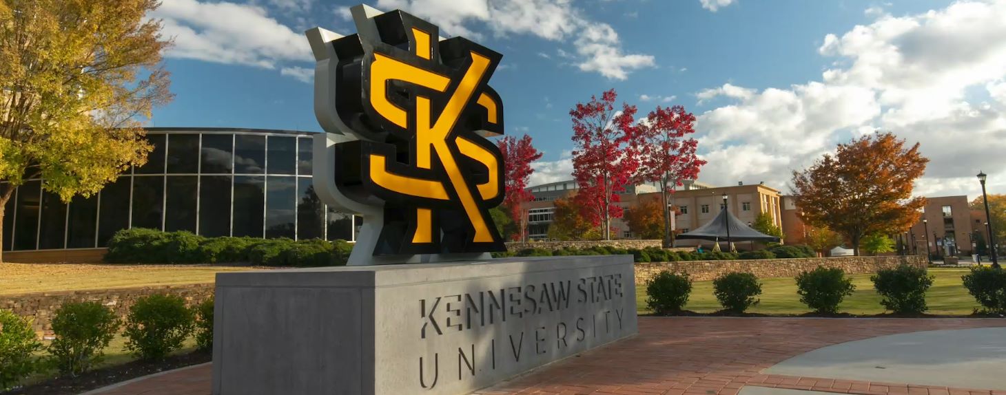 Kennesaw State University campus with large KSU logo sculpture and buildings