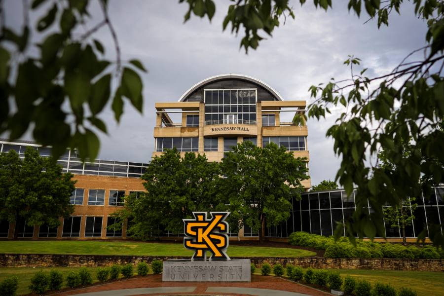 Kennesaw Hall at KSU with KSU sculpture and surrounding greenery