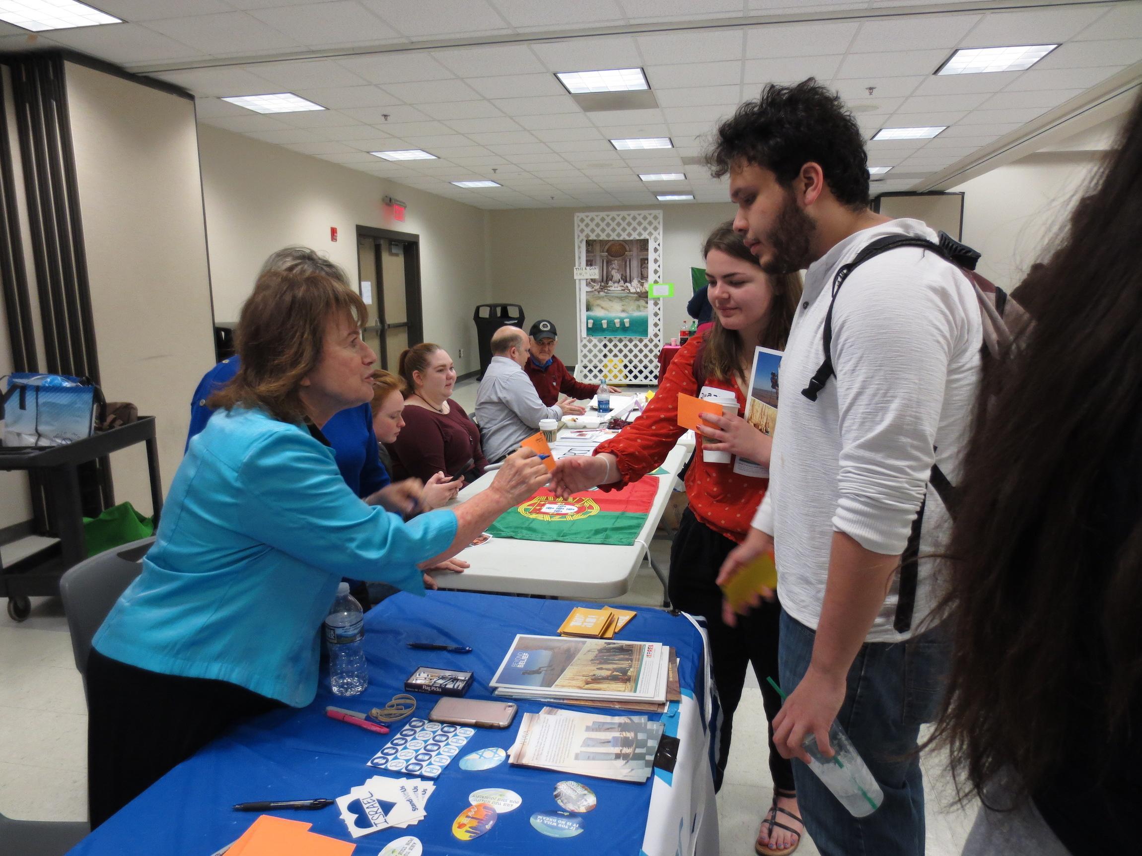  / students talking to professor at table 