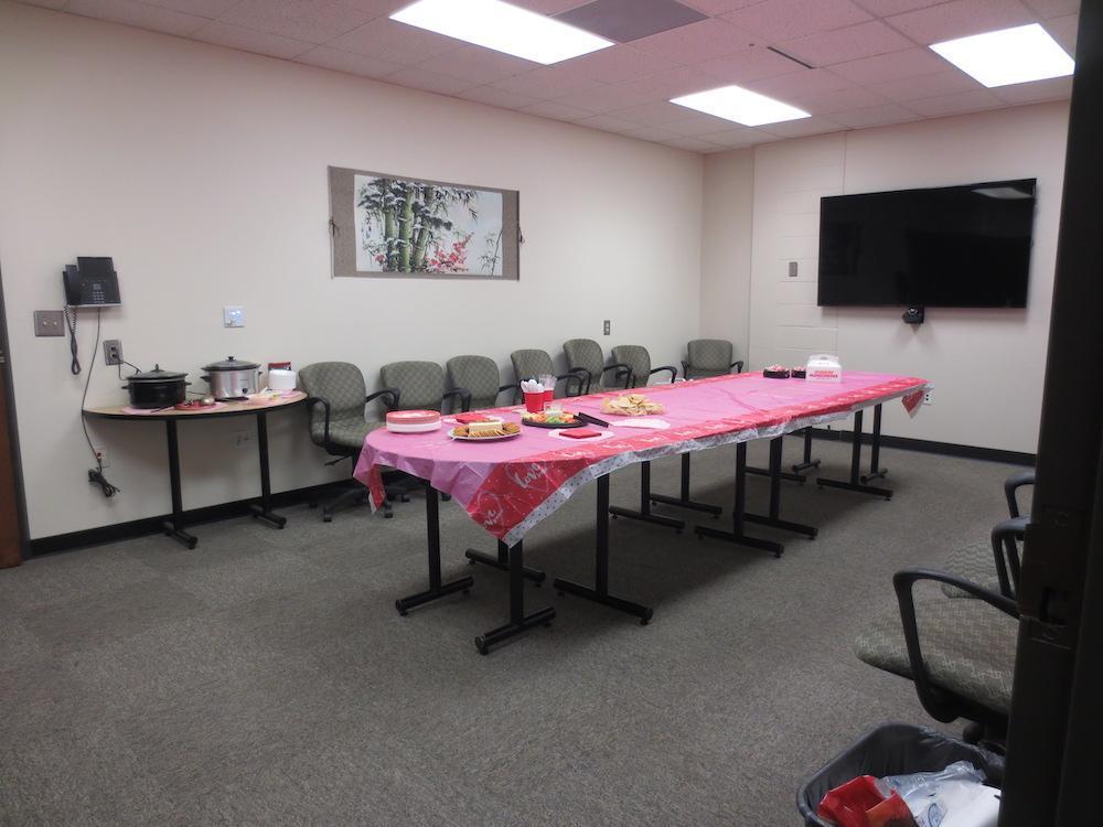  / meeting room with pink table covering and food 