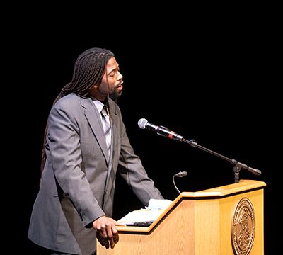 A man standing at a podium giving a lecture