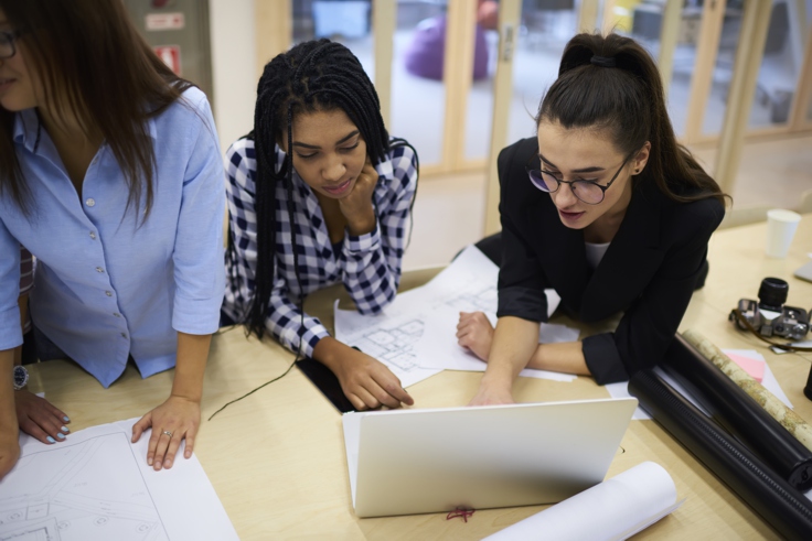 students working together on project looking at computer