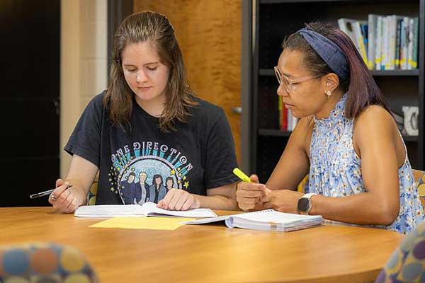 student and advisor in writing lab