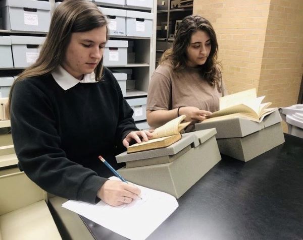 Two women interning at KSU's Department of Museums Archives and Rare Books.