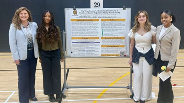 Dr. Jennifer Purcell with students presenting at the Symposium of Student Scholars