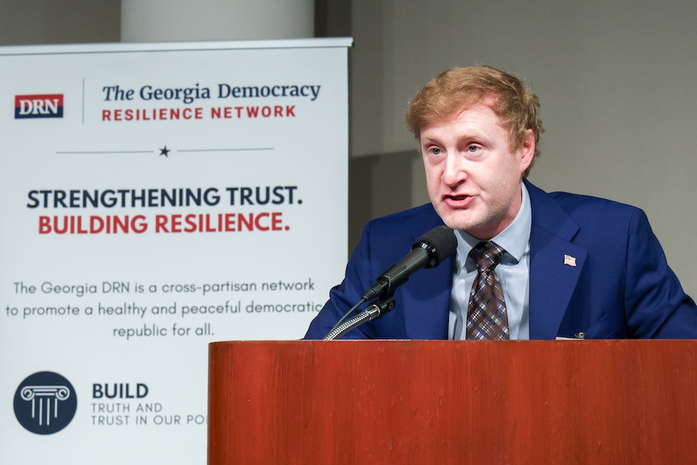 Dr. Eric Castater speaks at a Georgia Democracy Resilience Network event after receiving the 2026 Georgia Civic Excellence Award.