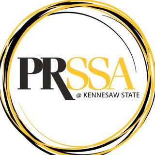 PRSSA at Kennesaw State logo with black and gold text encircled by abstract gold and black brushstroke rings.