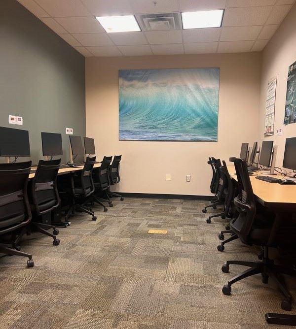 The KSU Psychology Lab, featuring two rows of desks with computers and chairs.