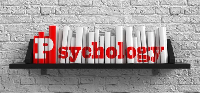 A row of red and white books on a shelf, spelling out the word "Psychology."