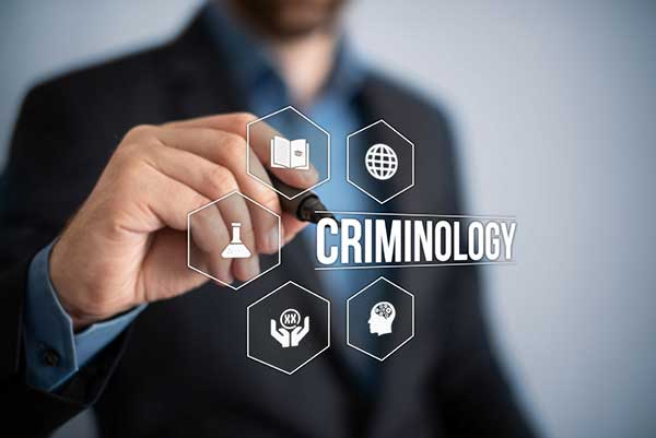 digital pen interacts with a virtual interface displaying the word "Criminology" alongside icons representing resources, sociology, and criminal justice concepts