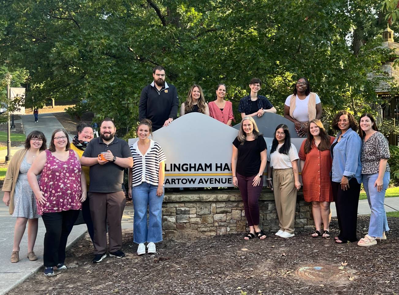 Radow College Undergraduate Advising Center advisors outside around the Willingham Hall sign.
