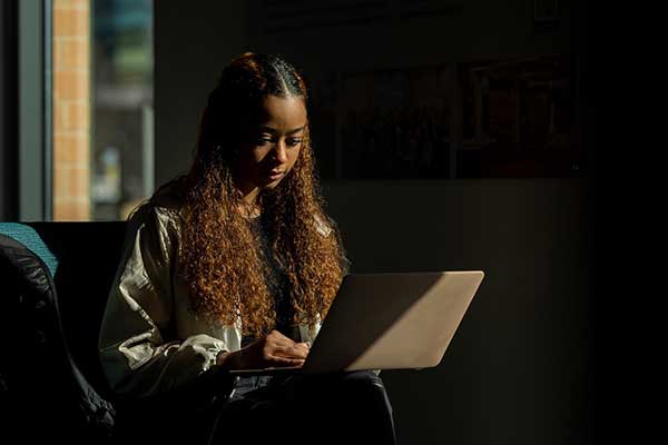 graduate student working at laptop