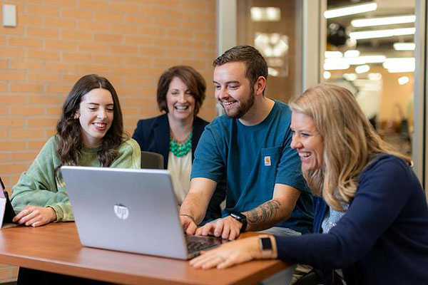 group of people in front of a computer