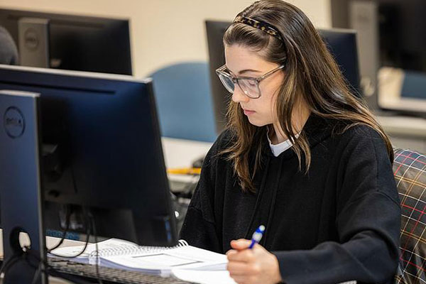 screen writer writing in front of a computer