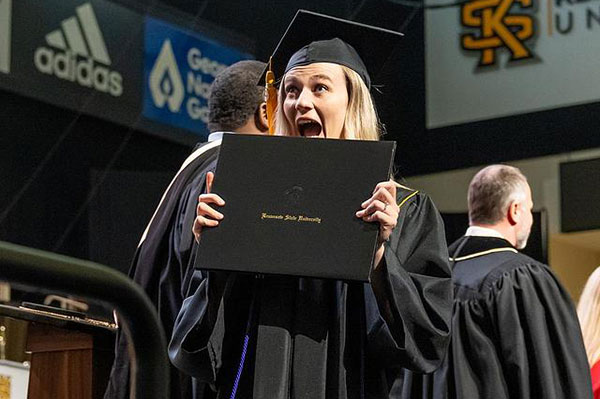 student with diploma at graduation