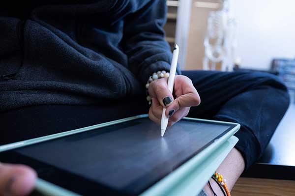 ksu student writing on tablet by hand