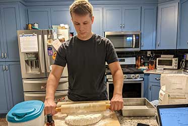 Eric Celler rolling out dough.