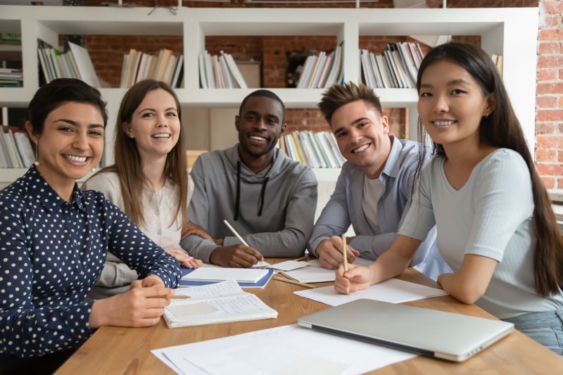 Students smiling in a classroom setting.