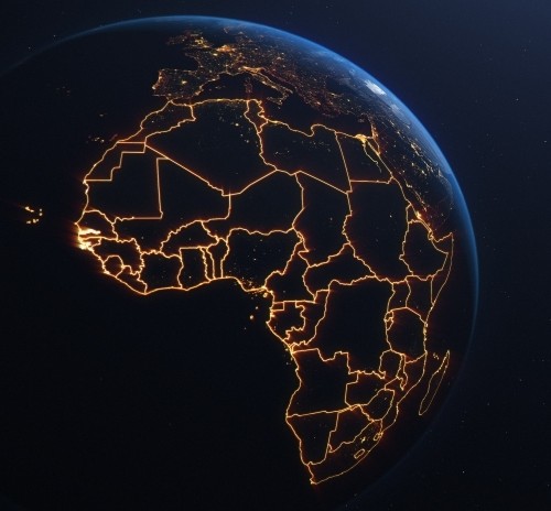 Satellite view of Africa at night with country borders glowing in golden light, emphasizing geopolitical divisions and connectivity.