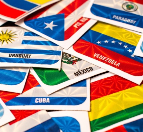 Cluster of small flags from Latin American countries including Uruguay, Cuba, Mexico, Venezuela, and Paraguay.