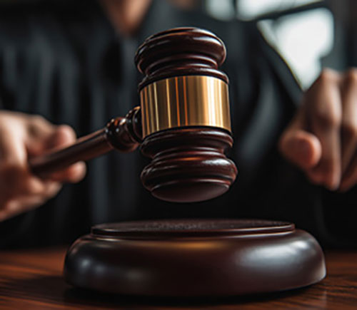 A judge's gavel rests on a wooden table, symbolizing authority in the criminal justice system.
