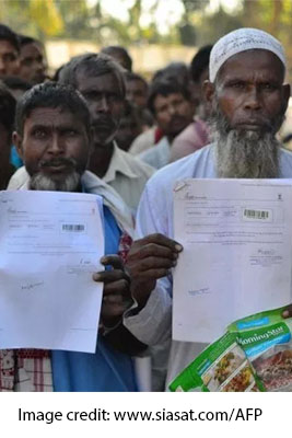 A group of men holding papers - Image credit: www.siasat.com/AFP