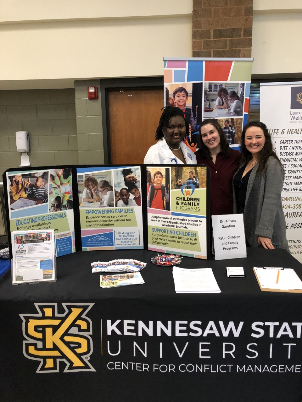 Interns with the Children and Family Programs help distribute information about the social skills workshops CfP offers