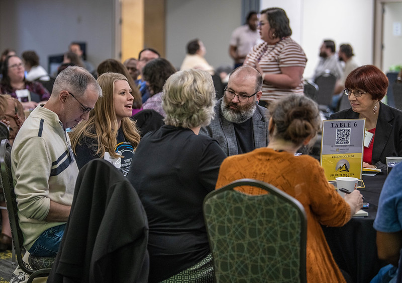 faculty at a presentation listening