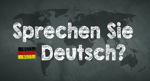 sprechen sie deutsch on blackboard with world map