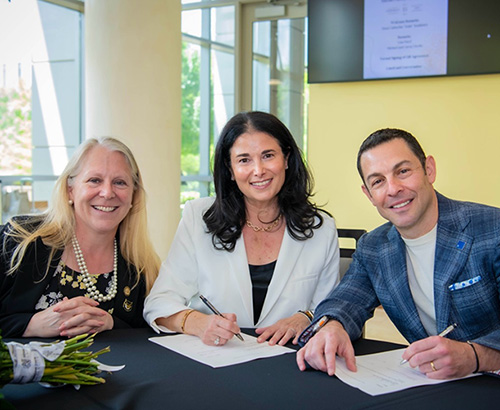 photo of CHSS grad student with the dean and assistant dean.