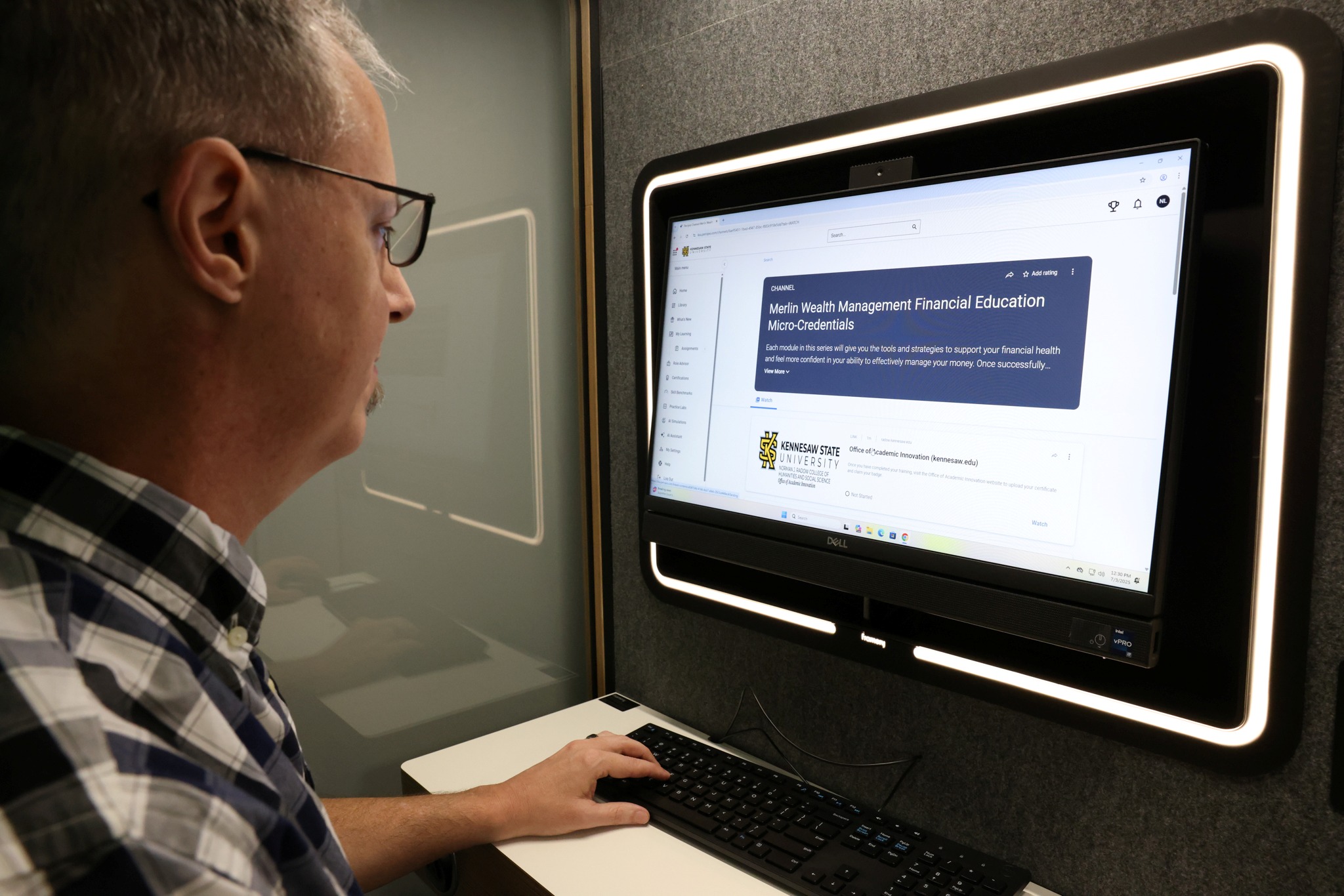 Faculty looking at laptop