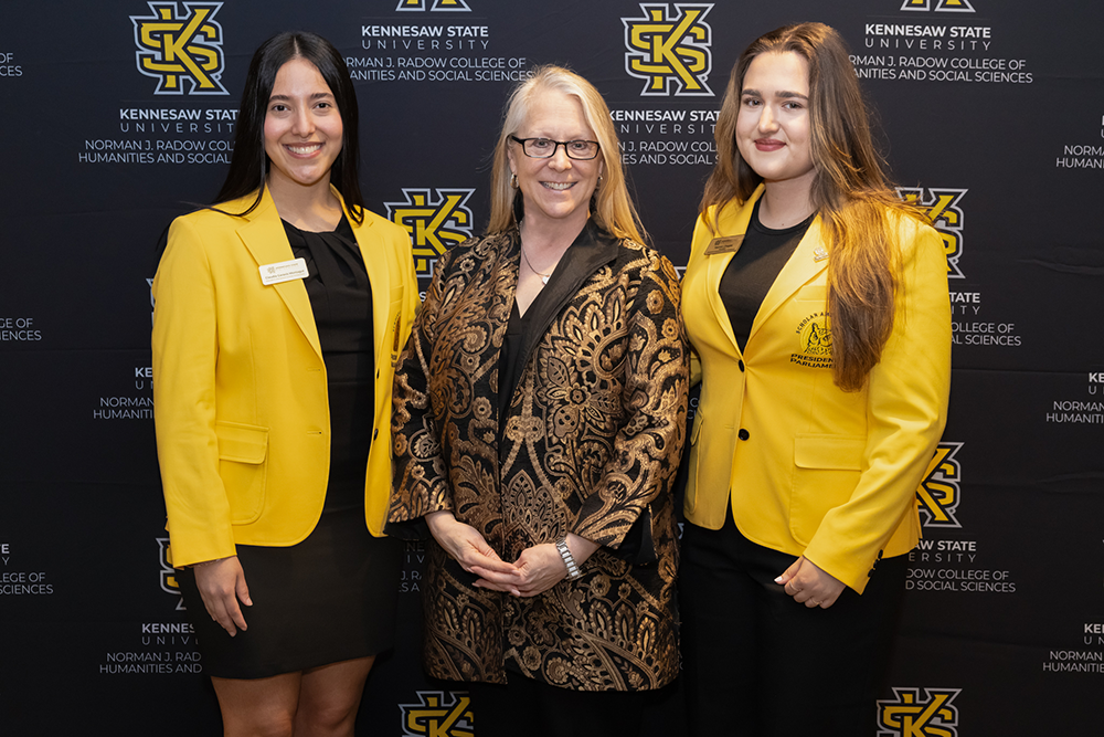 Student scholarship recipients Claudia Irina Garavis Montagut (L) and Yasmin Chagas (R) pose for a photo with Radow College Dean Catherine Kaukinen at the Radow College Scholarship Ceremony on March 25, 2026.