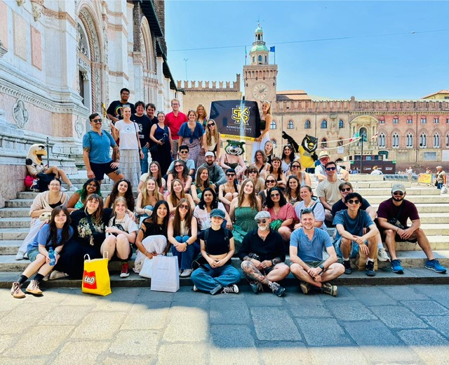 group sitting on stairs in Italy study abroad program