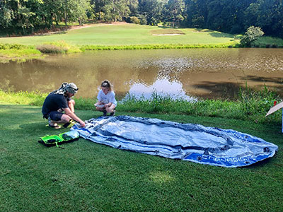 Tristan Bollenbaugh (l) works on the inflatable boat with fellow student Keely Gerety.