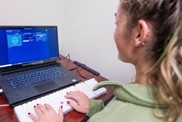 KSU undergraduate student Hopie Schlenker demonstrates how an eyetracker will measure participants' eye movements as part of one of the study assessments.